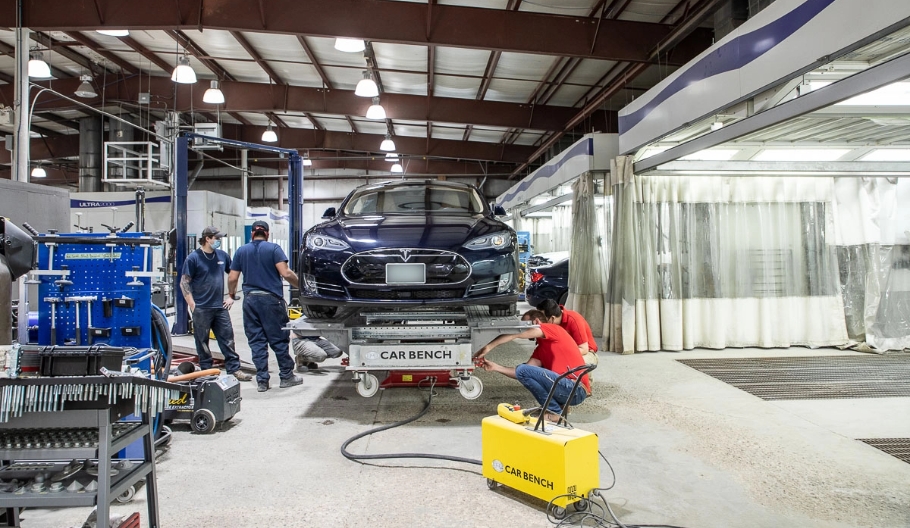 A couple of workers fixing a vehicle